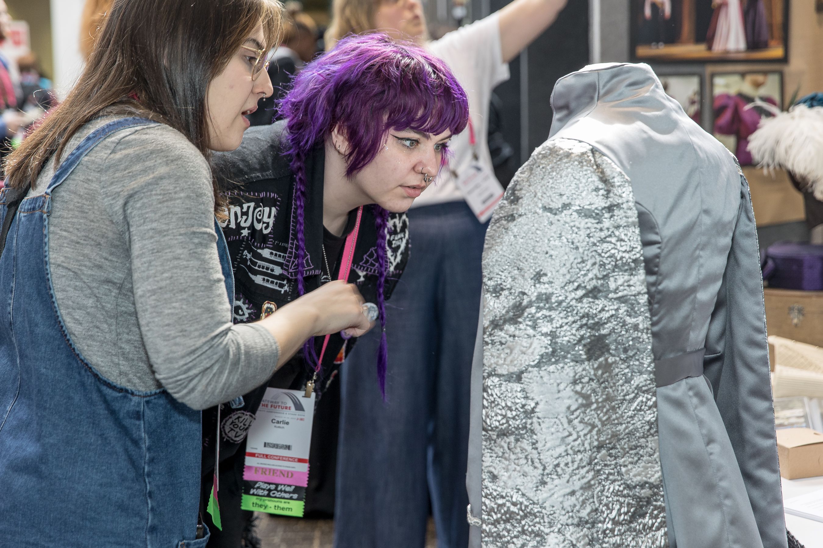 two people looking at a costume display at USITT23 in St. Louis
