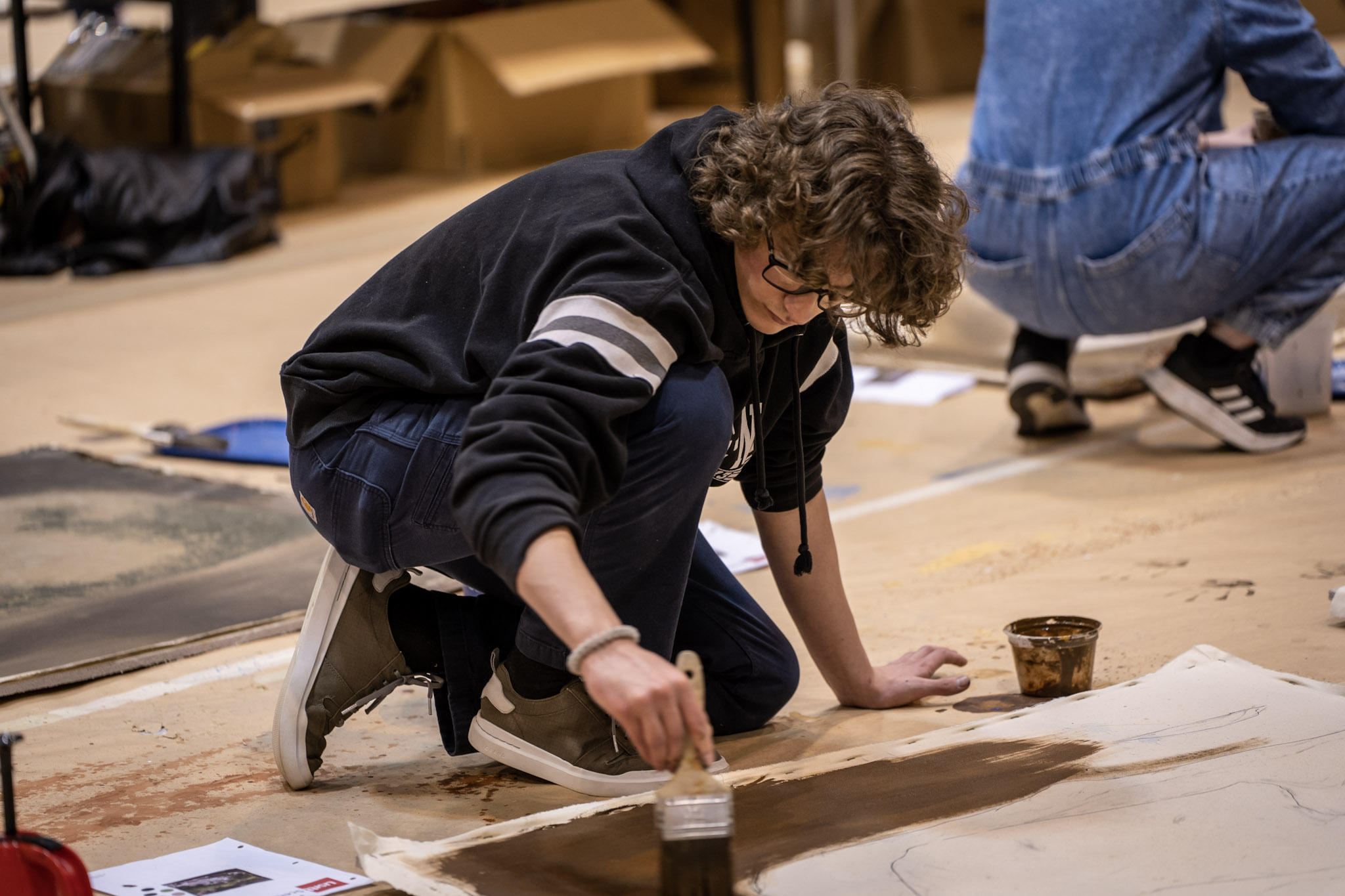 an attendee works on a painting project