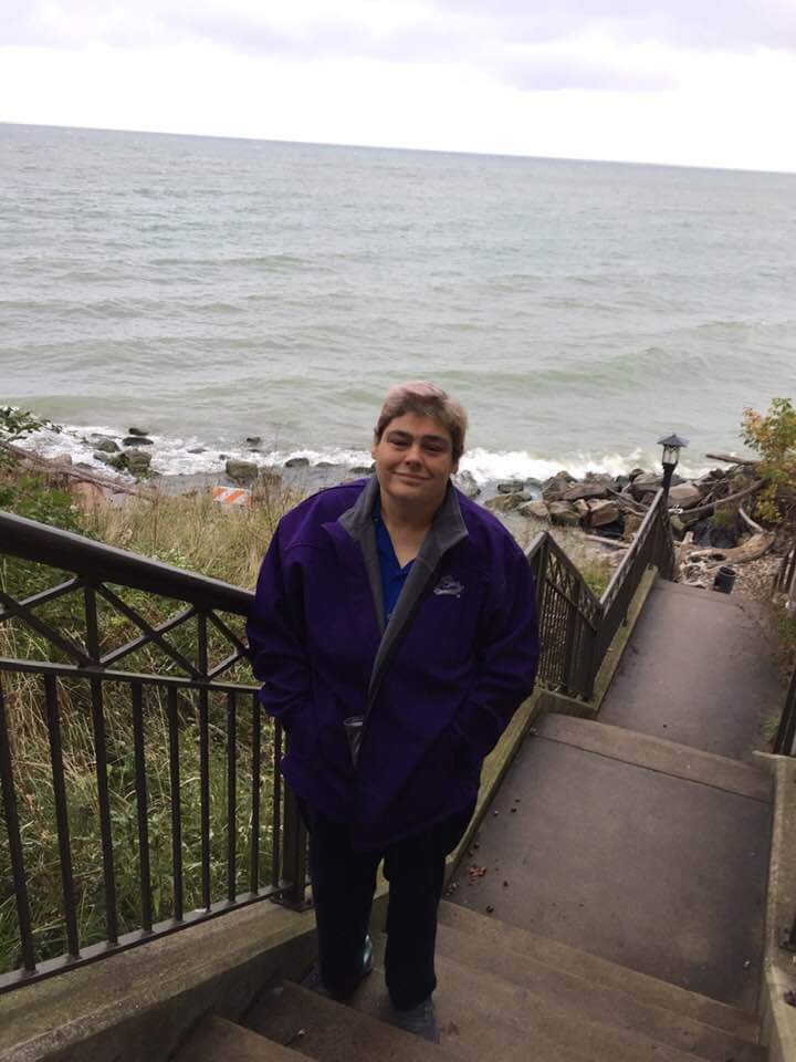 Lina (Jean) Burch standing on a set of stairs near a body of water