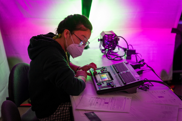 a person testing out a lighting board on the expo floor