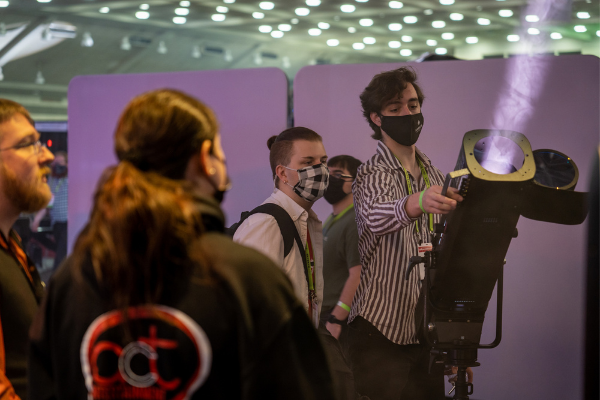 A person trying out a light at a booth on the Expo floor