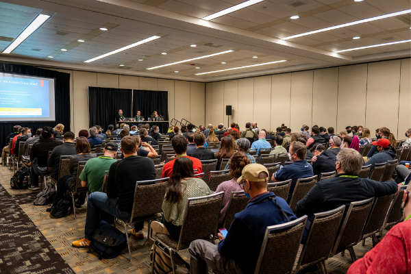 A large group of people attending a session