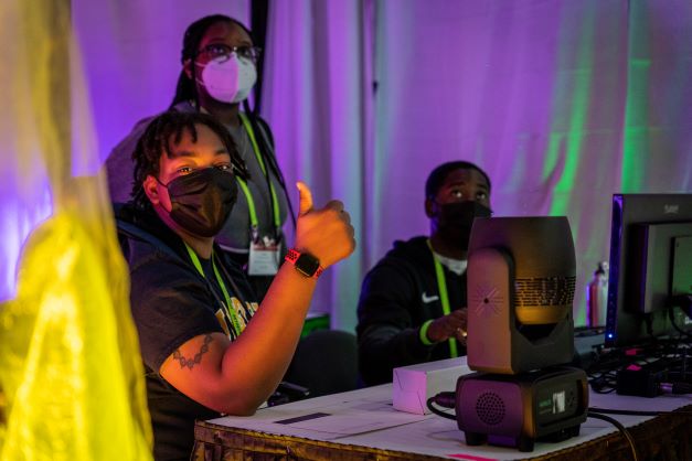 people using and testing out lights on the expo floor