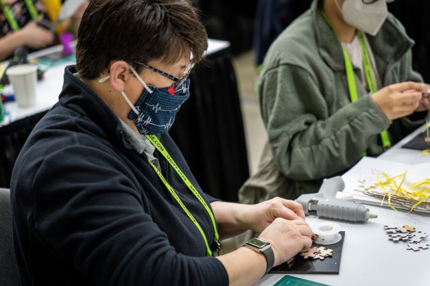 a person participating in a lab on the expo floor