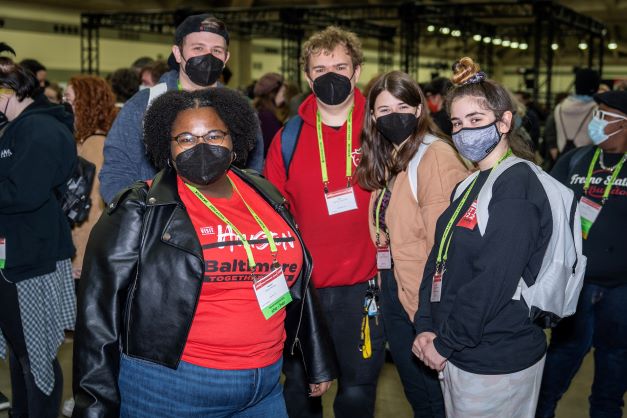 a group of people posing for a photo on the expo floor