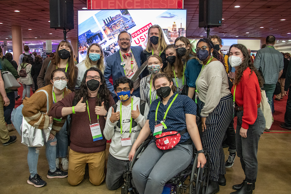 a group of people in front of the usitt22 stage expo entrance