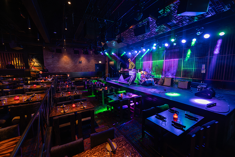 A wide-angle shot of the restaurant portion of Garcia's facing the stage.