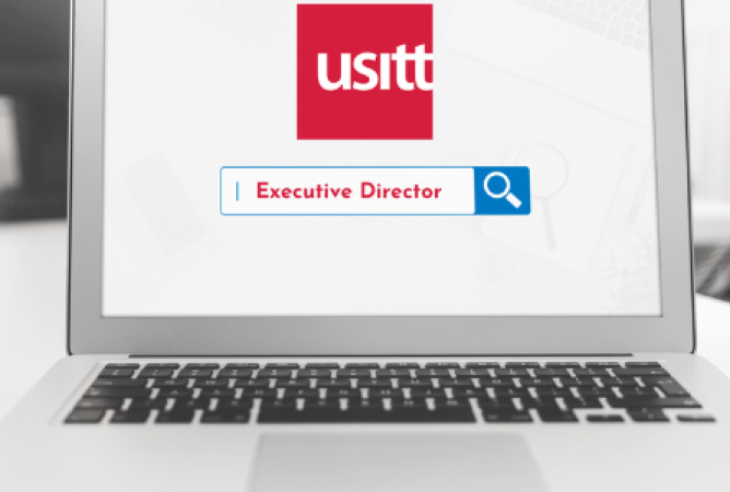 Laptop with usitt logo and a search bar with the words executive director typed into the search bar